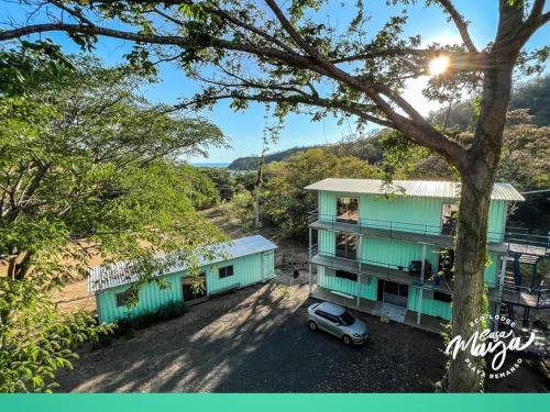 an aerial view of a building with a car parked in front at Casa Maya Private rooms seconds away from the beach, 200mbps in San Juan del Sur