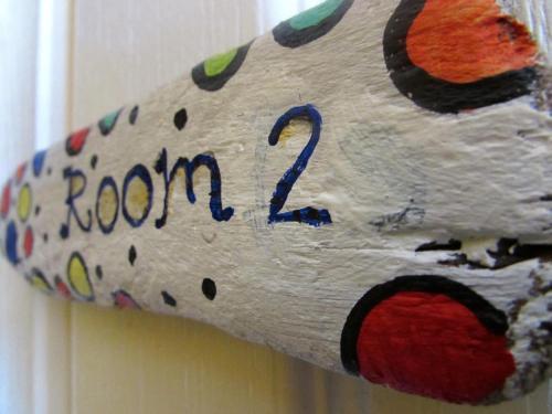 a wooden door with a room sign on it at Western House in Llangennith
