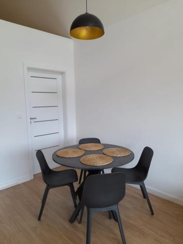 a table and chairs in a room with a wall at Domek na Kępie in Sromowce Wyżne