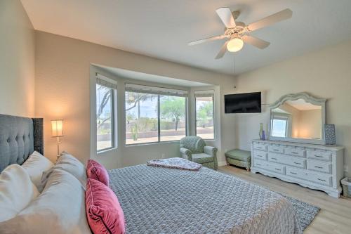 a bedroom with a bed and a ceiling fan at Welcoming Surprise Home with Patio and Spacious Yard in Surprise