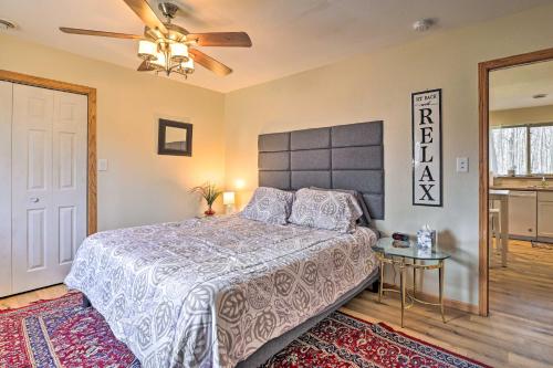 a bedroom with a bed and a ceiling fan at Mosinee Escape with Fire Pit - 1 Mi to River! in Mosinee