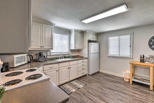 a kitchen with white cabinets and white appliances at Fremont Home, Near Reservoirs and Hiking Trails in Lyman