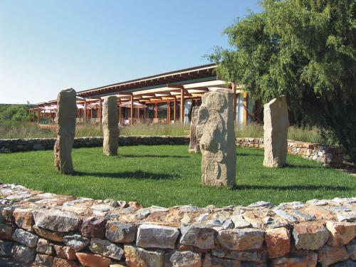 a group of stone statues in front of a building at Forum Homini Boutique Hotel in Krugersdorp