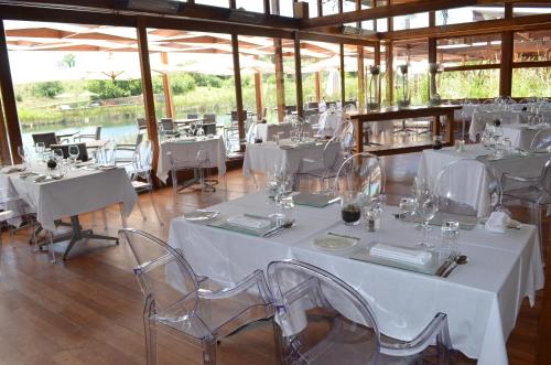 a room with white tables and chairs in a building at Forum Homini Boutique Hotel in Krugersdorp