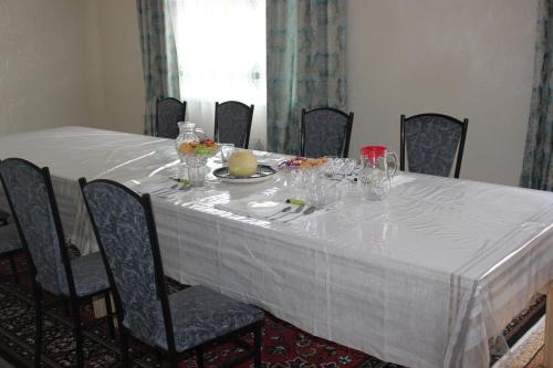 una mesa con un mantel blanco. en Uz-Anar Guest House, en Kochkorka