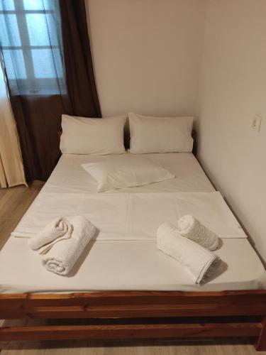 a bed with two towels and two pillows on it at CORFU OASIS studio in Neochorákion