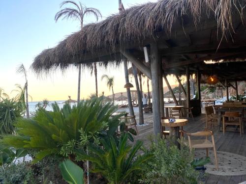 a restaurant on the beach with a view of the ocean at Maison Bellevue - 2 bdrm villa in Borsh beach in Borsh