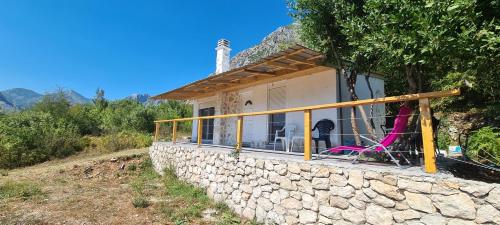 a house on a hill with a stone wall at Home of Laurel in Kotor