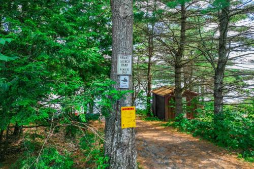 a sign on a tree in the woods at Falling Pines in Readfield