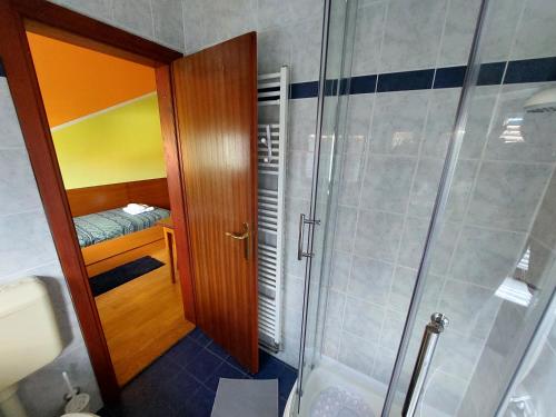 a bathroom with a shower and a walk in shower backdoor at Craft Beer Bar Rooms in Varaždin