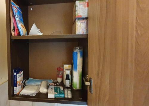 a cupboard with medicines and other items on it at Ваканция in Velingrad