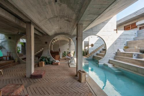 a building with a pool of water and stairs at Casa TO in Puerto Escondido