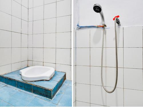 a bathroom with a shower with a toilet in it at SPOT ON 91393 Budiluhur 10 Homestay in Bandung