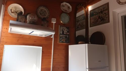 a kitchen with white cabinets and plates on the wall at Greenfields Country Club in Limassol