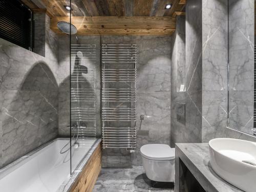 une salle de bain avec une baignoire, des toilettes et un lavabo dans l'établissement Appartement luxueux avec spa nordique et hammam au cœur de Val d'Isère - FR-1-567-6, à Val dʼIsère