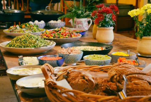 a table with many bowls of food on it at Beit Oren Hotel in Bet Oren