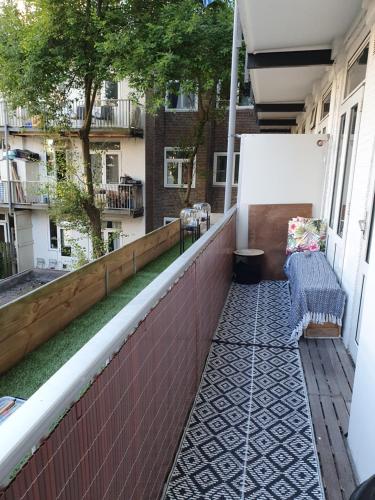 a balcony with a bench on the side of a building at Appartement in Stadsdeel West in Amsterdam