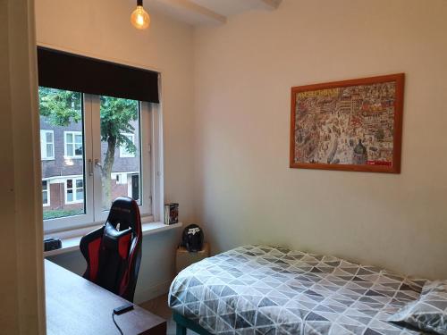 een slaapkamer met een bed en een raam bij Appartement in Stadsdeel West in Amsterdam