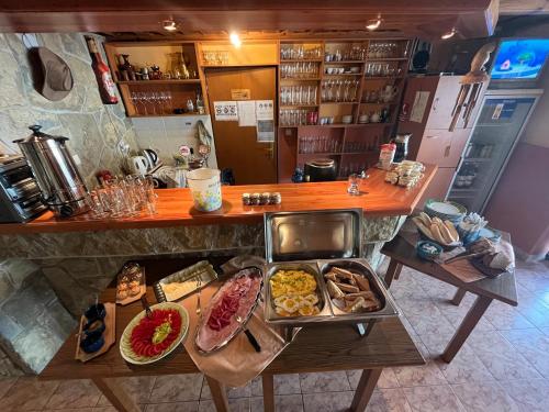 a counter with many different types of food on it at Penzion Siesta Grand in Hrabušice