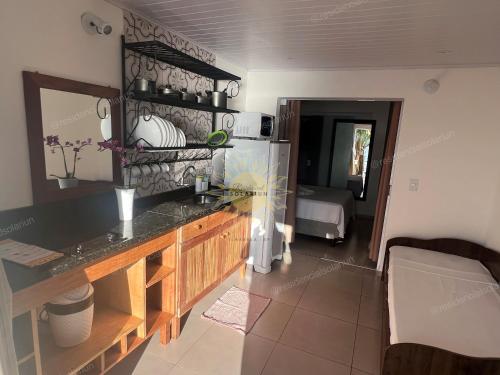 a kitchen with a counter top in a room at Residencial Solariun Ilhabela in Ilhabela
