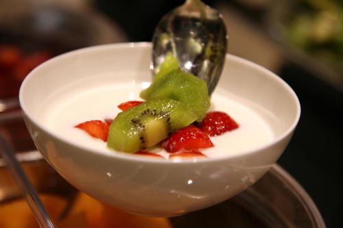 a bowl of fruit with a spoon in it at Ego Hotel in Ancona