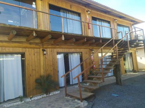 a wooden building with a staircase on the side of it at Formosa Suites in Bonito