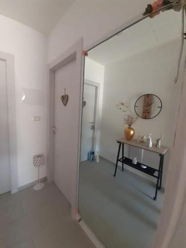 a bathroom with a shower with a mirror and a table at B&b la Casa dei Nonni in Silvi Paese