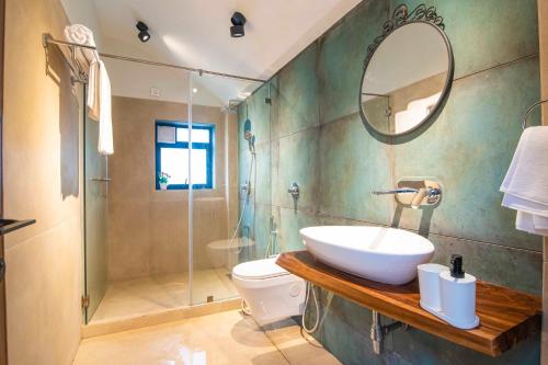 uma casa de banho com um lavatório, um WC e um chuveiro em Castle Rock Villa By Tropicana Stays em Lonavala