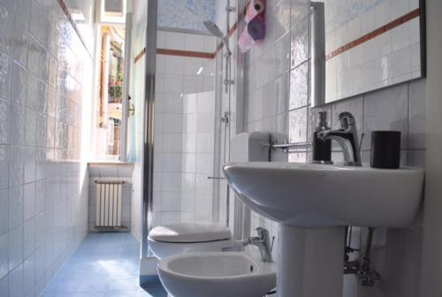 bagno bianco con lavandino e servizi igienici di San Peter's Corner a Roma