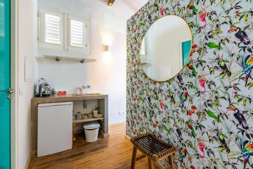 a bathroom with a mirror on a wall at Wynwood Boutique Hotel in Willemstad