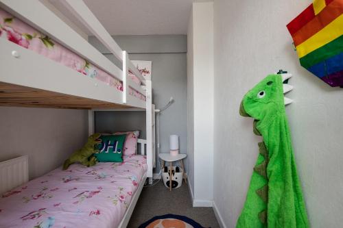 a childs bedroom with a bunk bed and a dinosaur toy at Tranquility Nook in Portsmouth