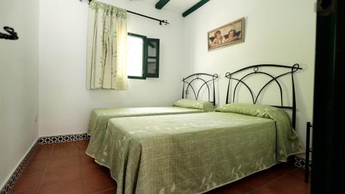 Cama o camas de una habitación en Aparthotel El Cañuelo