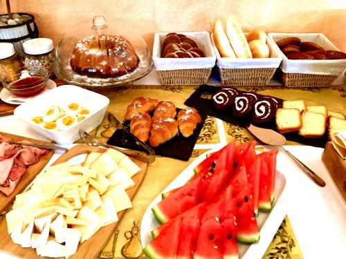 a table topped with different types of cheese and fruit at Hotel Karolina in Karlovy Vary