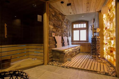 a room with a sauna with a stone wall at Schlosshotel Elgersburg in Elgersburg