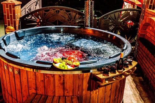 a hot tub with a bowl of fruit in it at PENSIUNEA MIHAELA-Transalpina in Novaci