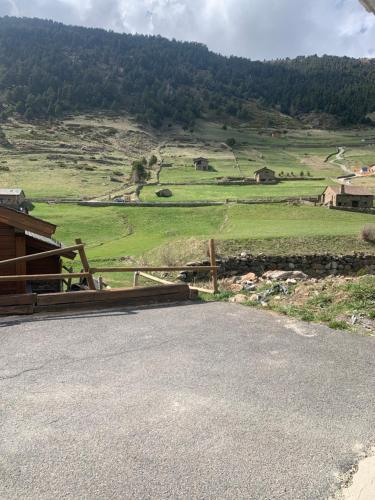 a view of a farm with a fence and a field at PORT DRET - Peu del Riu HUT 8141 - Vall d'Incles in Incles