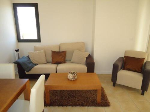 a living room with a couch and a coffee table at Casa Patrick in Murcia
