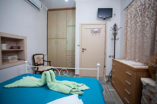 a room with a bed and a door with a television at Vicky's House in Kos Town