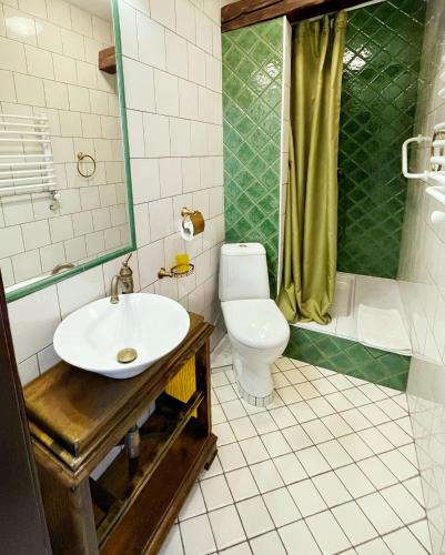a bathroom with a sink and a toilet and a shower at Villa Zoryany Dvir in Skhidnitsa