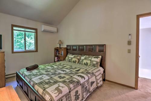 a bedroom with a bed and a window at Deck and Resort Amenities Pocono Lake Home in Pocono Lake