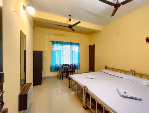 西里古里的住宿－Ushashee Amidst Nature，一间卧室配有两张床和一张桌椅