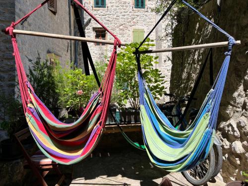 two colorful hammocks hanging from a building at HealthyStudio512 Apartments in Kotor