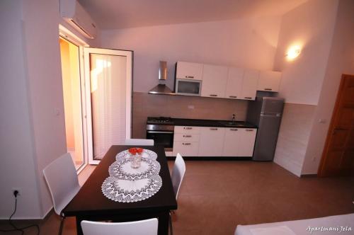 a kitchen with a table with a cake on it at Apartments Jela in Metajna