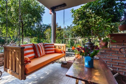 a porch with a couch and a table at Casa de Khasia in Zugdidi