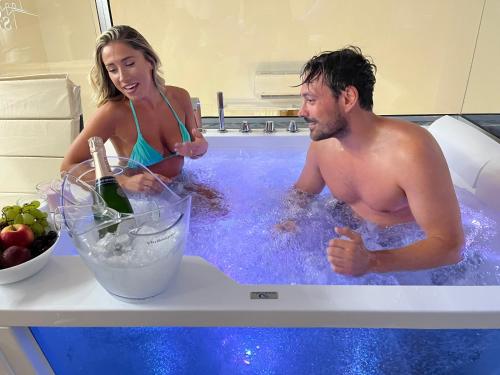 a man and a woman in a bath tub at Centro Storico in Pozzuoli