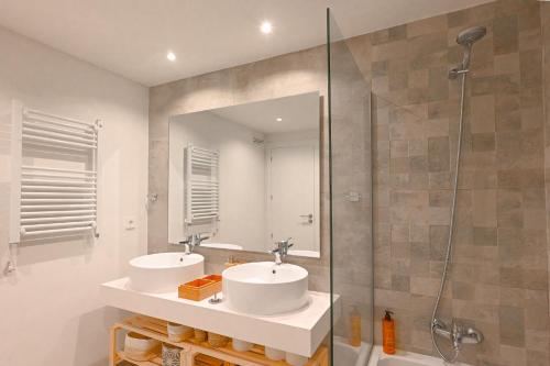 a bathroom with two sinks and a shower at Seashell Infinity Luxury Apartment in Estepona