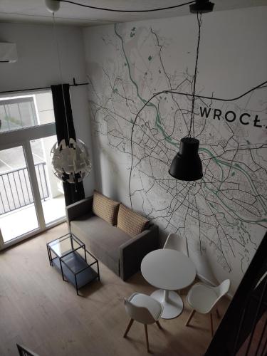 a living room with a couch and a table at Apartament AirPort in Wrocław