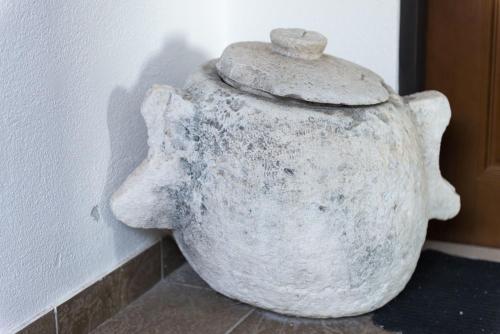 a large stone jug sitting next to a wall at Apartments Vitorin in Sobra