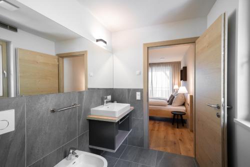 a bathroom with a sink and a toilet at Oberzerod Apartments in Siusi