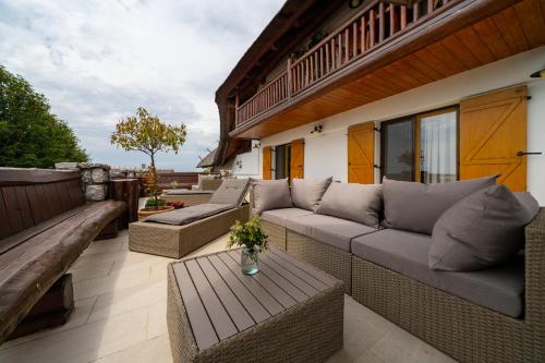a patio with couches and a table on a building at Hiša vina Cuk in Lendava